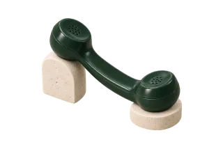 Dark green telephone handset on limestone supports